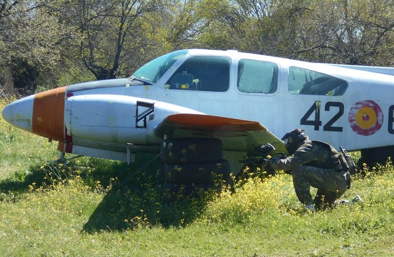 Jugador escondido en el lateral del avión de Gran Paintball Madrid
