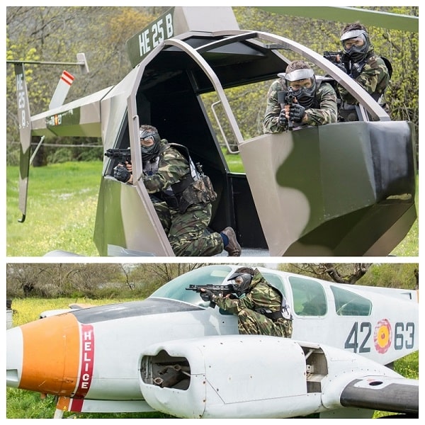 Dos equipos jugando al Paintball en Gran Paintball Madrid escondidos tras el helicóptero y el avión